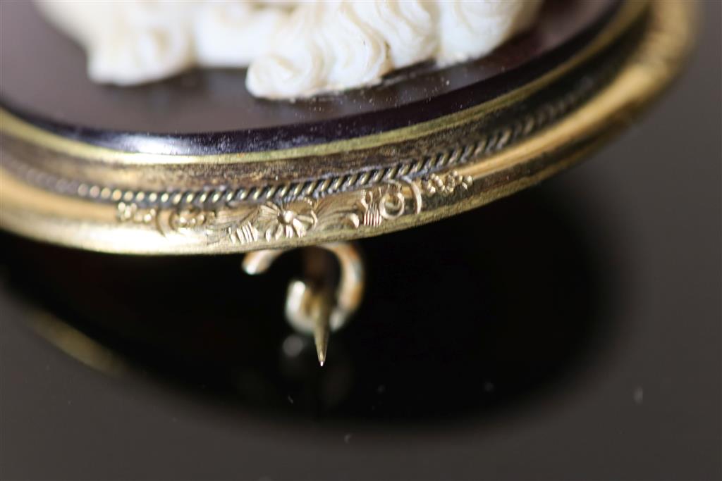 A Victorian gilt metal mounted composition glass? oval cameo brooch, carved with bust of a lady to dexter, 45mm.